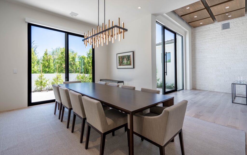 Modern dining room with large windows.
